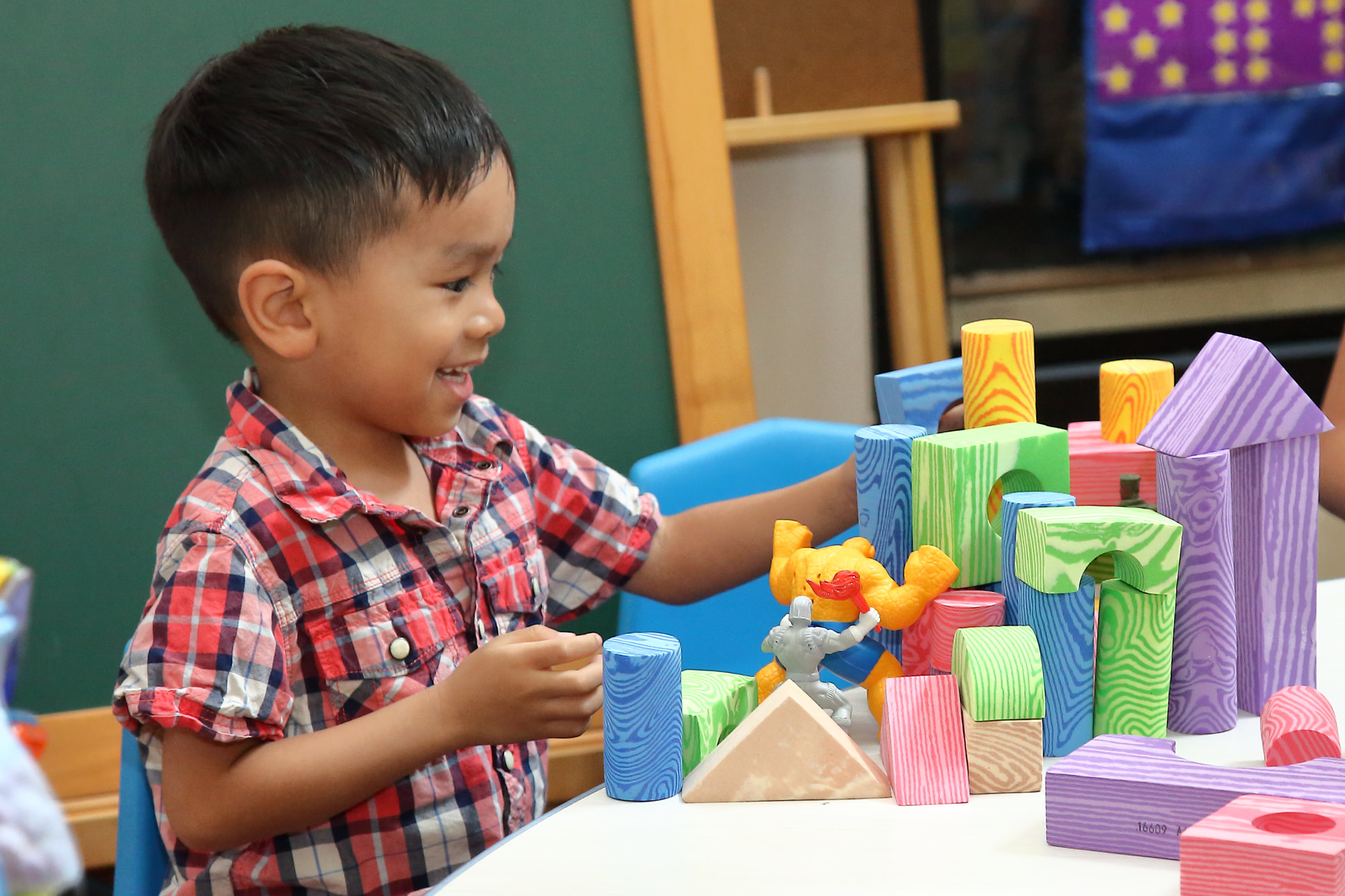 Child playing with colorful building blocks